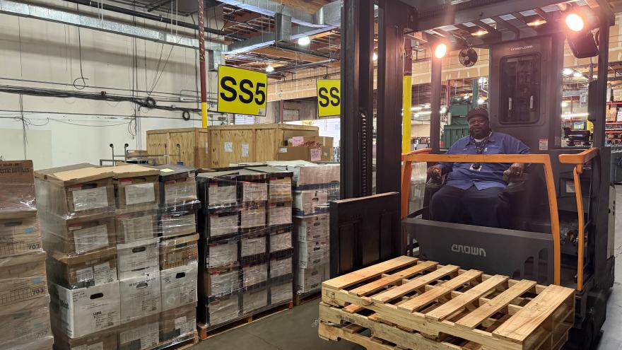 donte_casey_on_a_forklift_in_a_warehouse_of_boxes_and_pallets