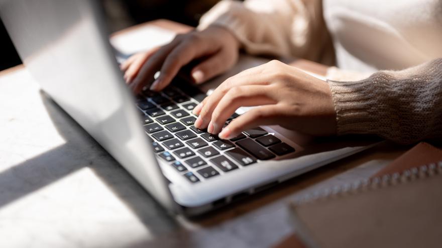 woman typing on laptop keyboard