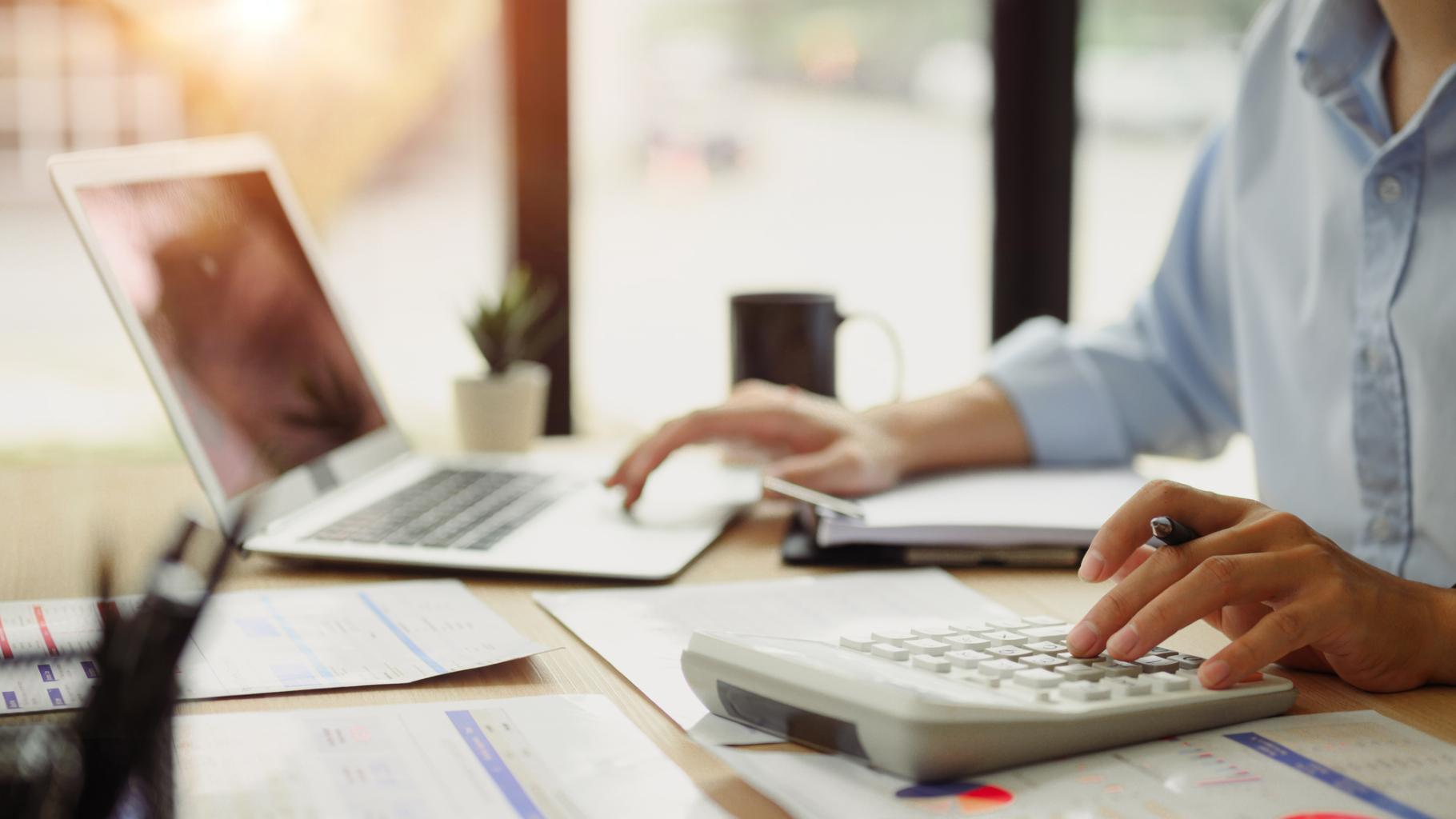 Businessman calculating finances at office desk